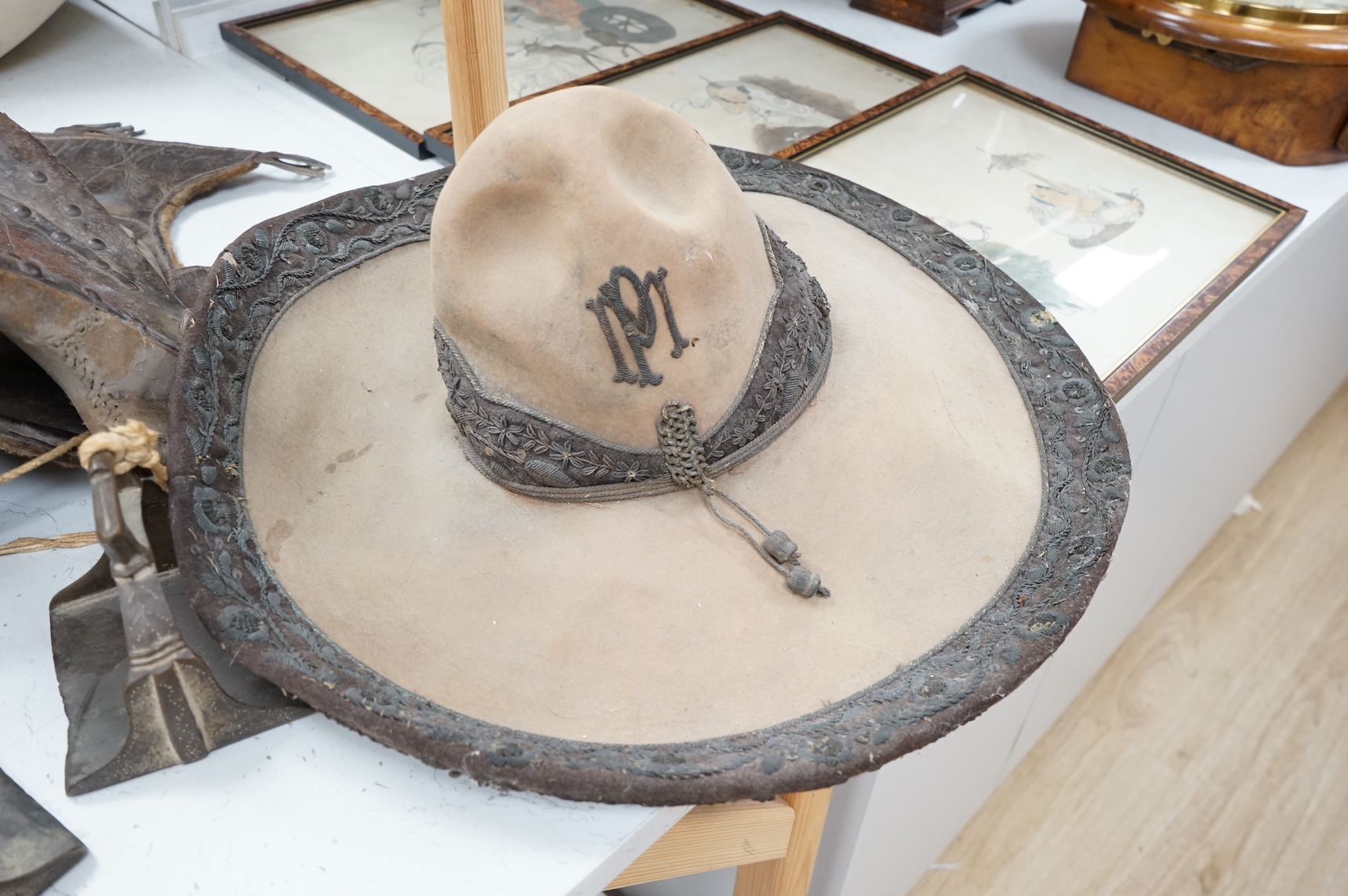 A Spanish Colonial leather saddle and a Spanish Colonial bullion work sombrero, saddle 59cm long